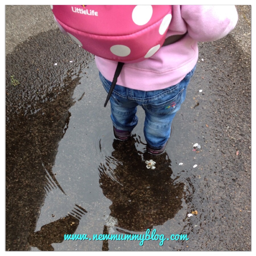 16 month old toddler splashing in puddles