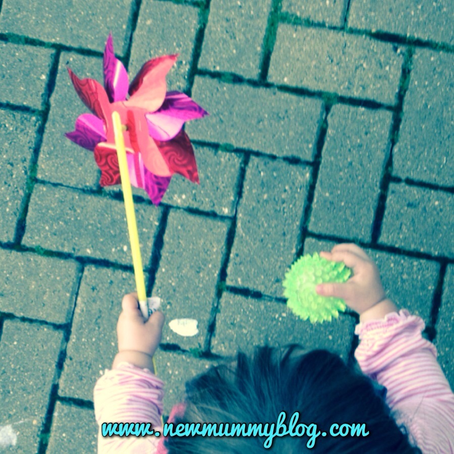 #MySundayPhoto. toddler with windmill and spikey ball  going shopping