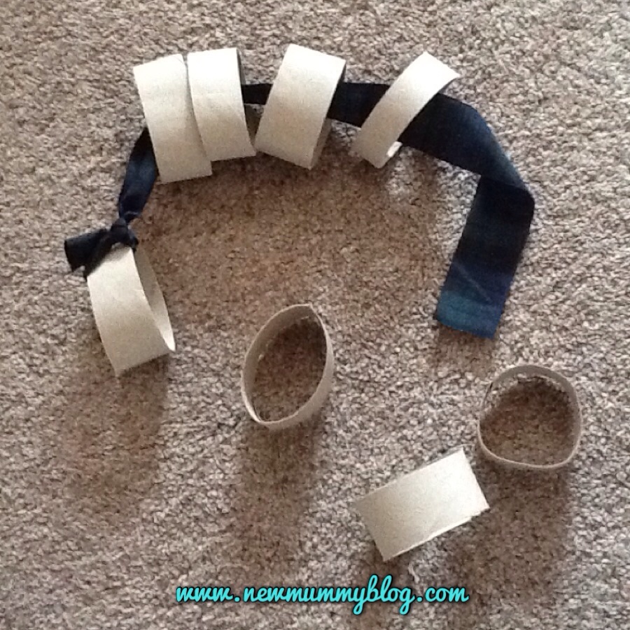 Make a ribbon and cardboard tube threading toy