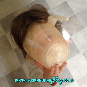 toddler with a jug on her head