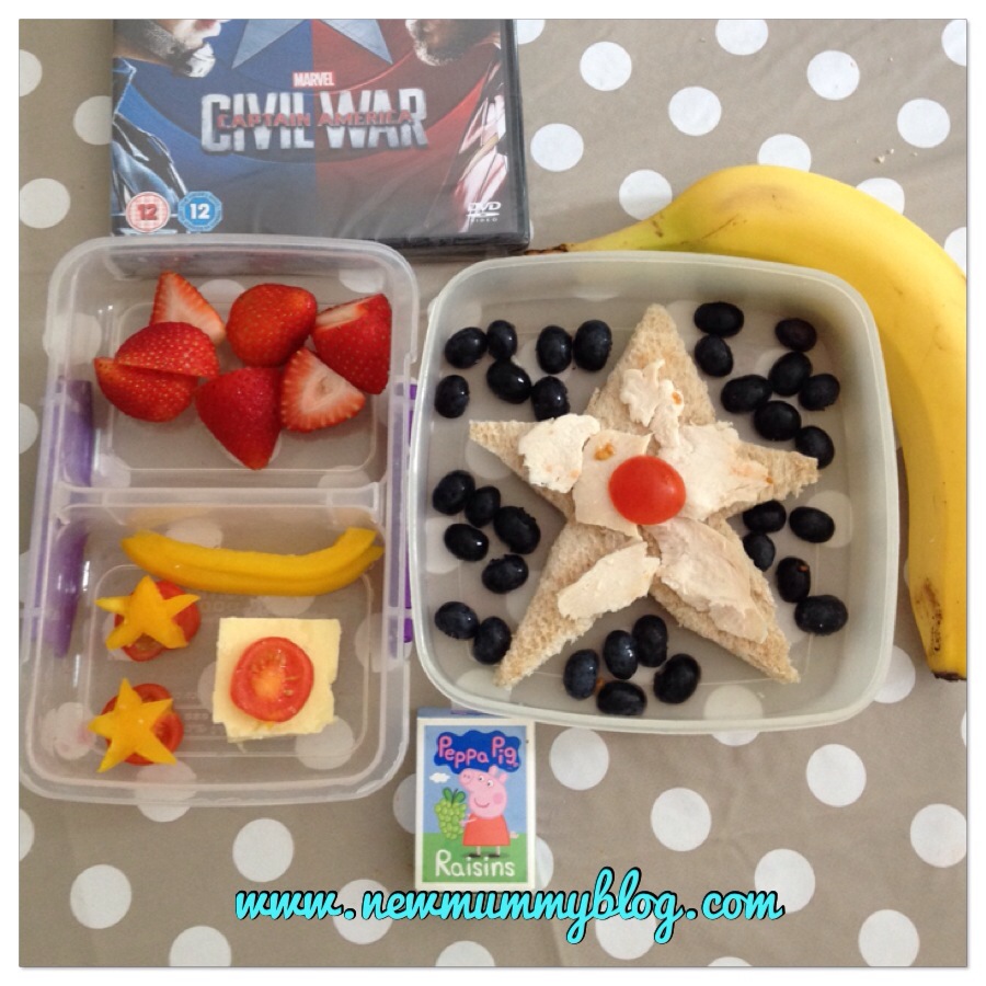 captain america DVD theme healthy lunch blueberries surround a star sandwich with a side of strawberries, pepper stars on tomatoes, with a banana and raisins.