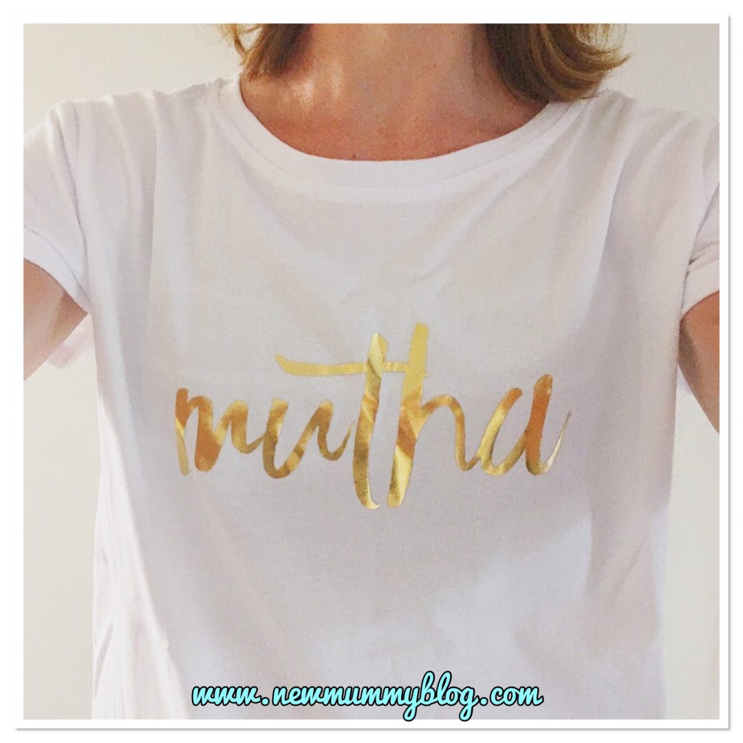 Wearing a white Milky Tee Company breastfeeding t-shirt which has Mutha written in gold letters, with long zips on the sides