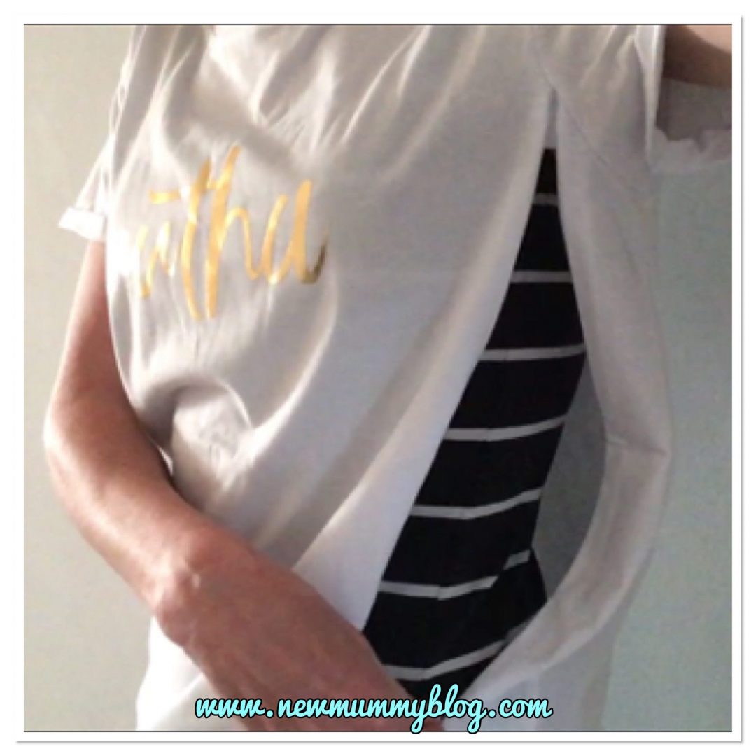 Wearing a white gold lettered Mutha Milky Tee Company breastfeeding t-shirt with long zips on the sides - showing how the 14” zips open to enable easy breastfeeding