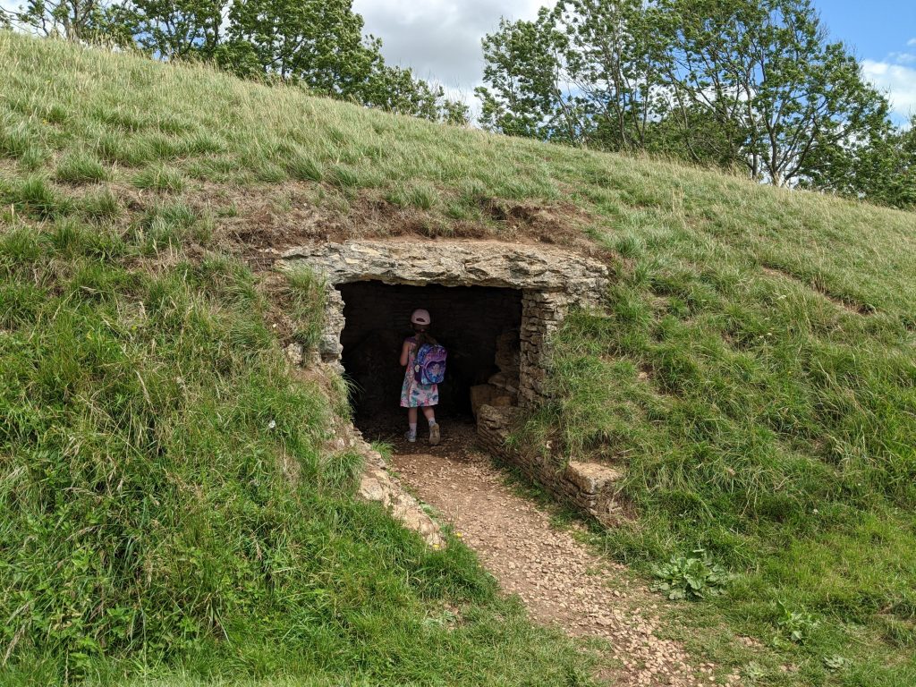 Bela's Knap long barrow, fun family walk near Cheltenham, Gloucestershire. Exploring the long barrow chambers